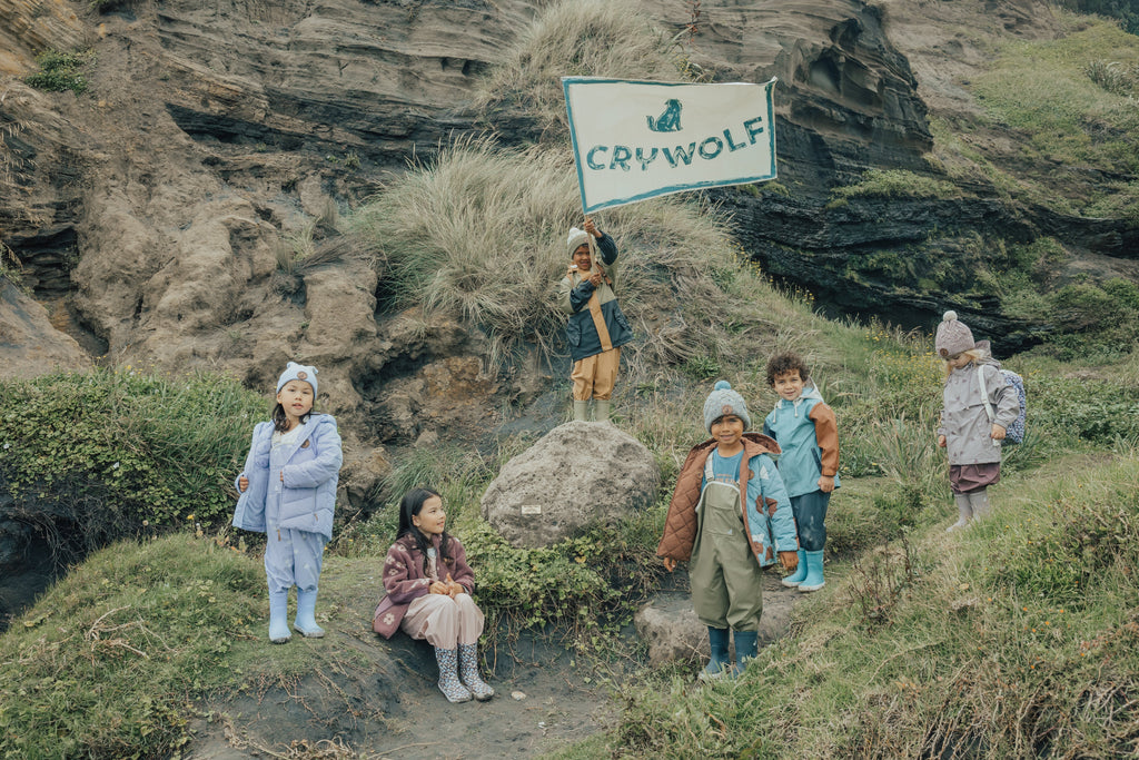 Children wearing Crywolf autumn / winter clothing playing at the beach