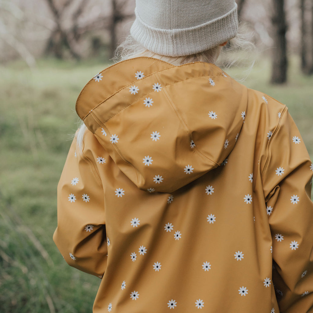 Child Wearing A Crywolf Waterproof Play Jacket Wild Flower