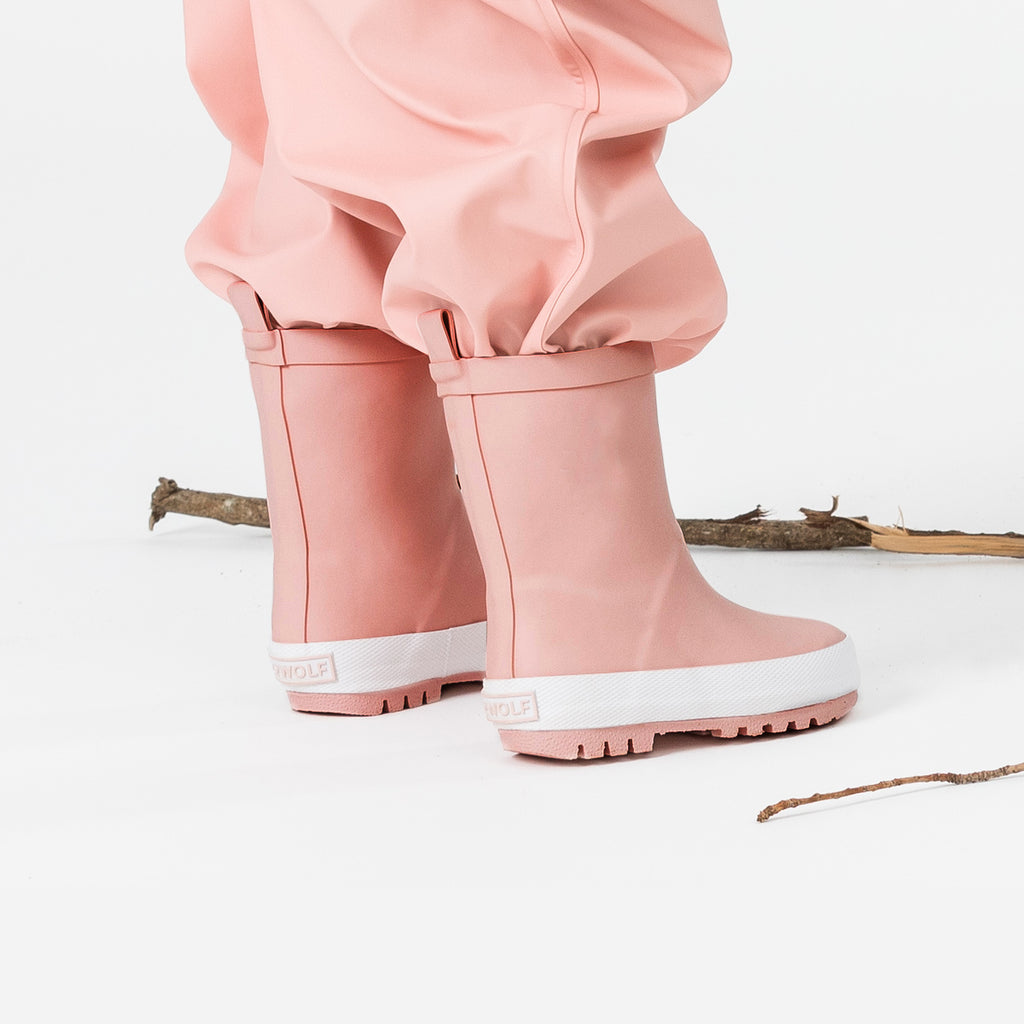 A Child Wearing Crywolf Rainboots Blush - Side View